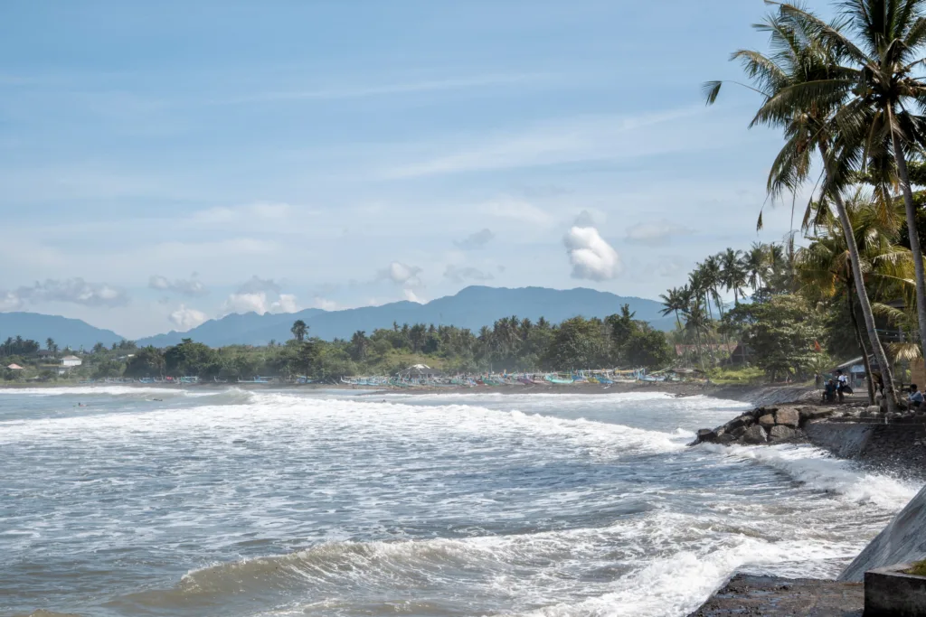 Beach with rock formation under a cloudy sky on Bali